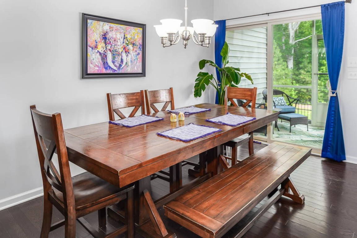 68 Argonaut Drive Durham, NC 27705 - Photo 7 of 29 a view of a dining room with furniture a chandelier and wooden floor