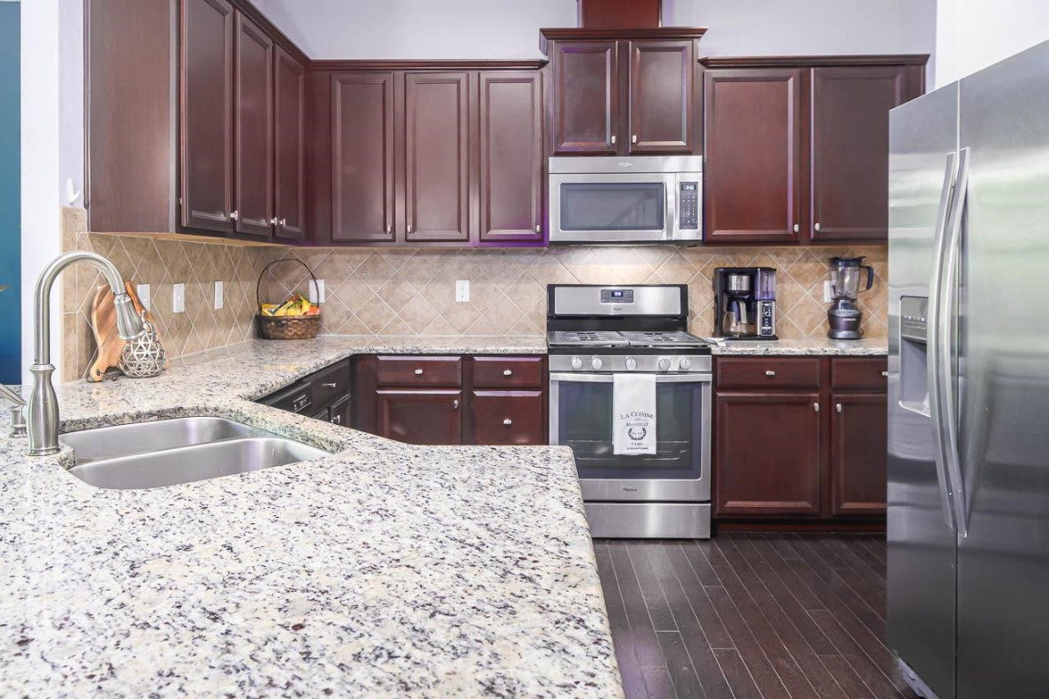68 Argonaut Drive Durham, NC 27705 - Photo 10 of 29 a kitchen with stainless steel appliances granite countertop a sink stove and refrigerator