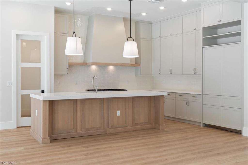 699 1st Street Northwest Naples, FL 34120 - Photo 14 of 42 a view of a kitchen with a sink and a refrigerator