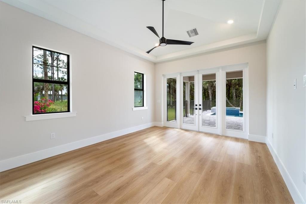 699 1st Street Northwest Naples, FL 34120 - Photo 18 of 42 a view of an empty room with a window and wooden floor
