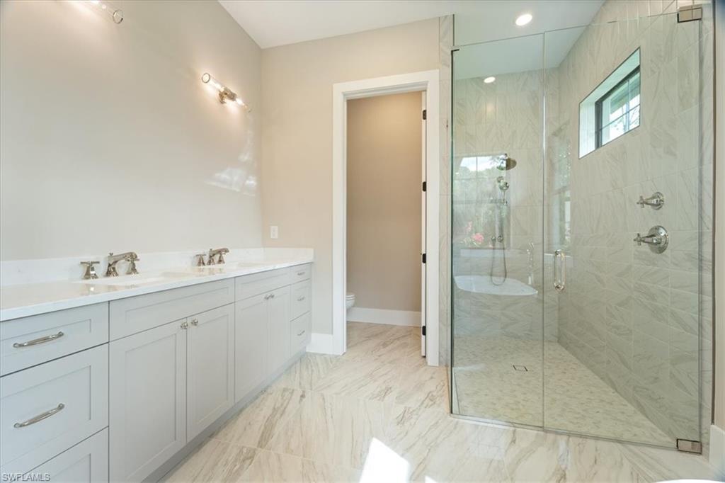 699 1st Street Northwest Naples, FL 34120 - Photo 20 of 42 a spacious bathroom with a shower