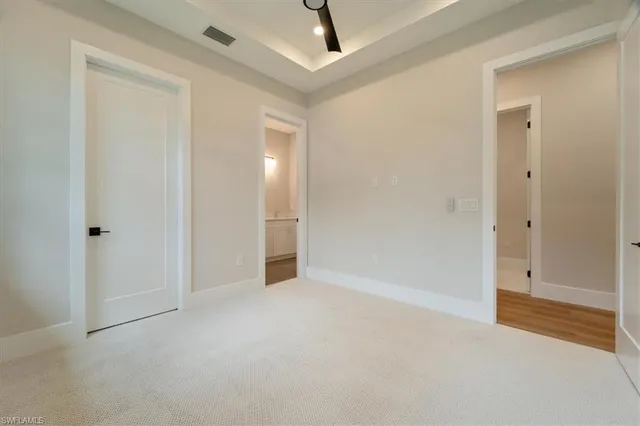 a view of an empty room and bathroom