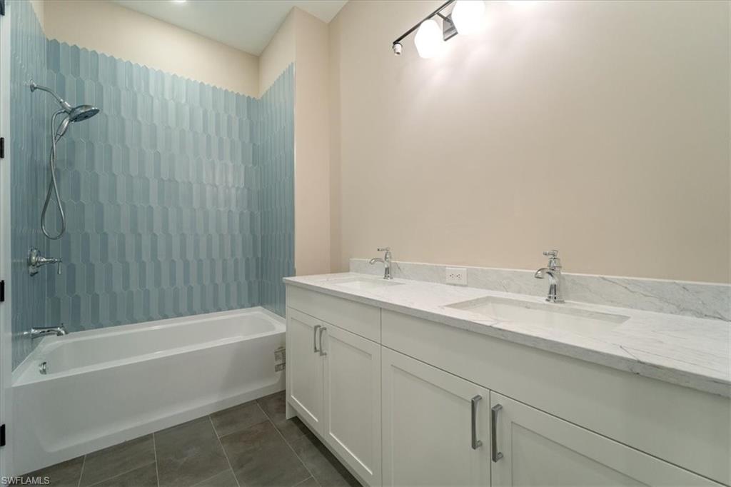 699 1st Street Northwest Naples, FL 34120 - Photo 32 of 42 a bathroom with a tub a sink and mirror