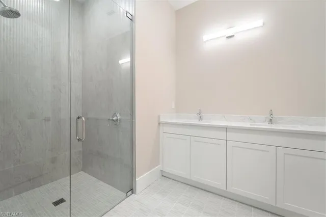 a bathroom with a shower sink and mirror