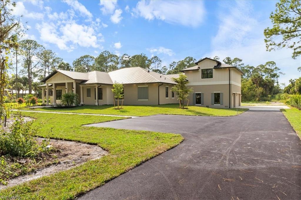 699 1st Street Northwest Naples, FL 34120 - Photo 4 of 42 a view of outdoor space yard and front view of a house