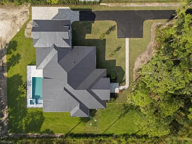 an aerial view of a house with yard swimming pool and outdoor seating