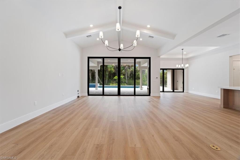699 1st Street Northwest Naples, FL 34120 - Photo 8 of 42 a view of an empty room with wooden floor and a window
