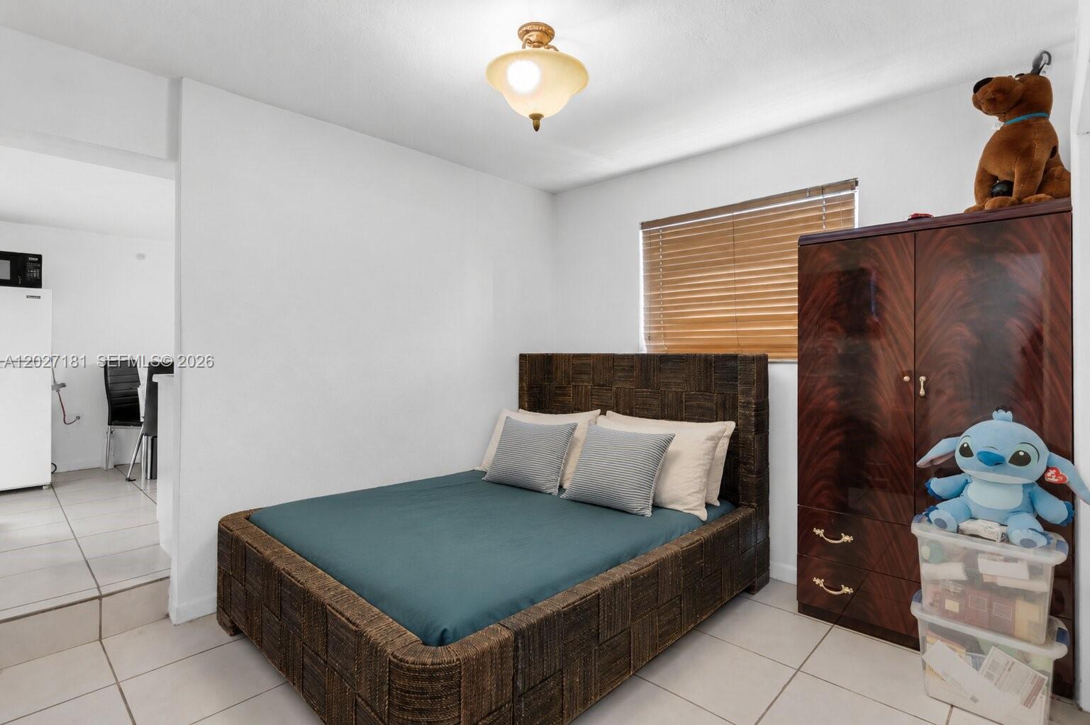 15440 Southwest 294th Terrace Homestead, FL 33033 - Photo 22 of 31 a bedroom with a bed and a chandelier