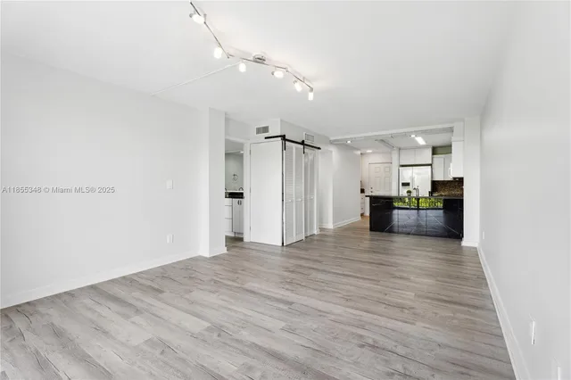 a view of kitchen and kitchen with microwave