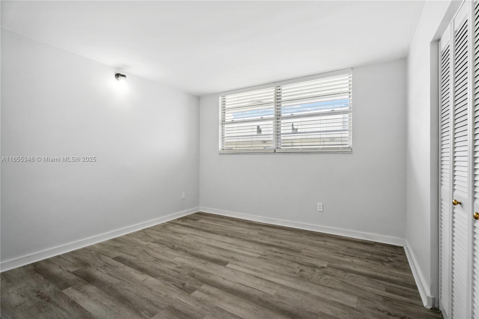 750 Northeast 64th Street, Unit B500 Miami, FL 33138 - Photo 23 of 29 wooden floor in an empty room with a window