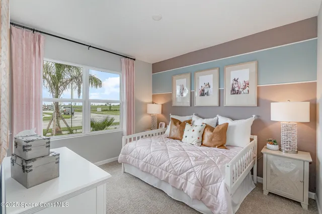 a bedroom with a bed and a large window