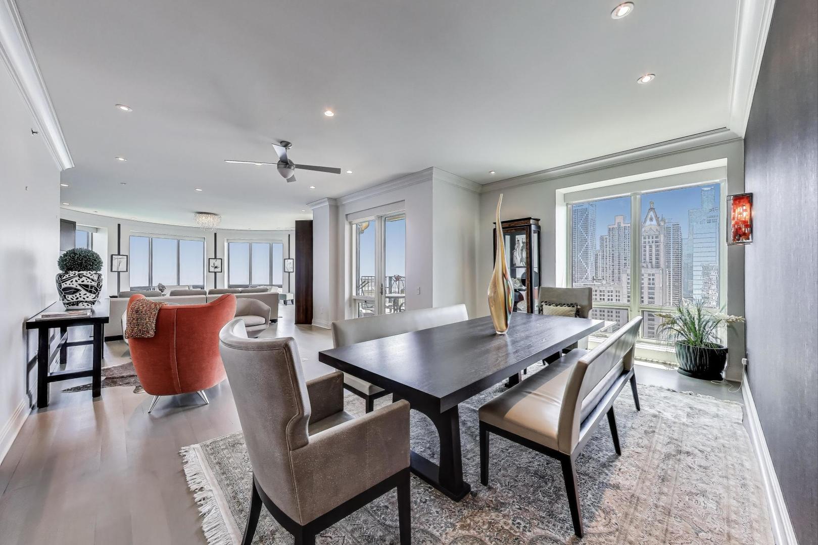 840 North Lake Shore Drive, Unit 2401 Chicago, IL 60611 - Photo 15 of 40 a view of a dining room with furniture window and wooden floor