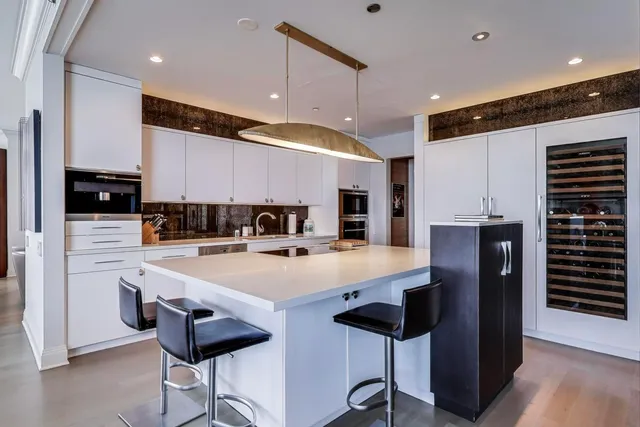 a kitchen that has cabinets a sink and a stove
