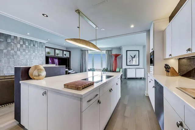 a large kitchen with stainless steel appliances granite countertop a sink and a refrigerator