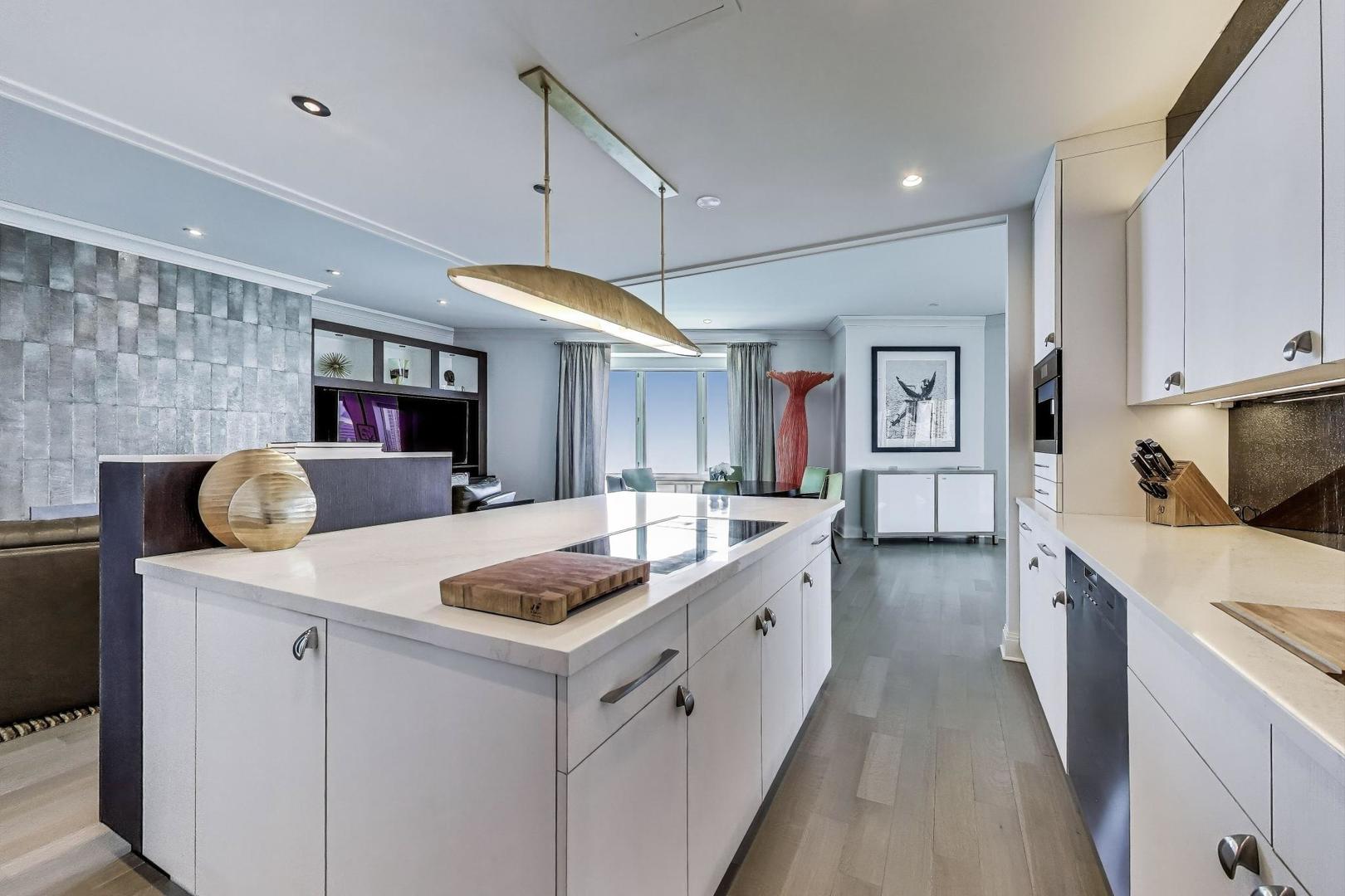 840 North Lake Shore Drive, Unit 2401 Chicago, IL 60611 - Photo 17 of 40 a kitchen that has cabinets a sink and a stove