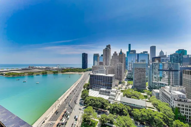 a spacious bedroom with a bed and a flat screen tv