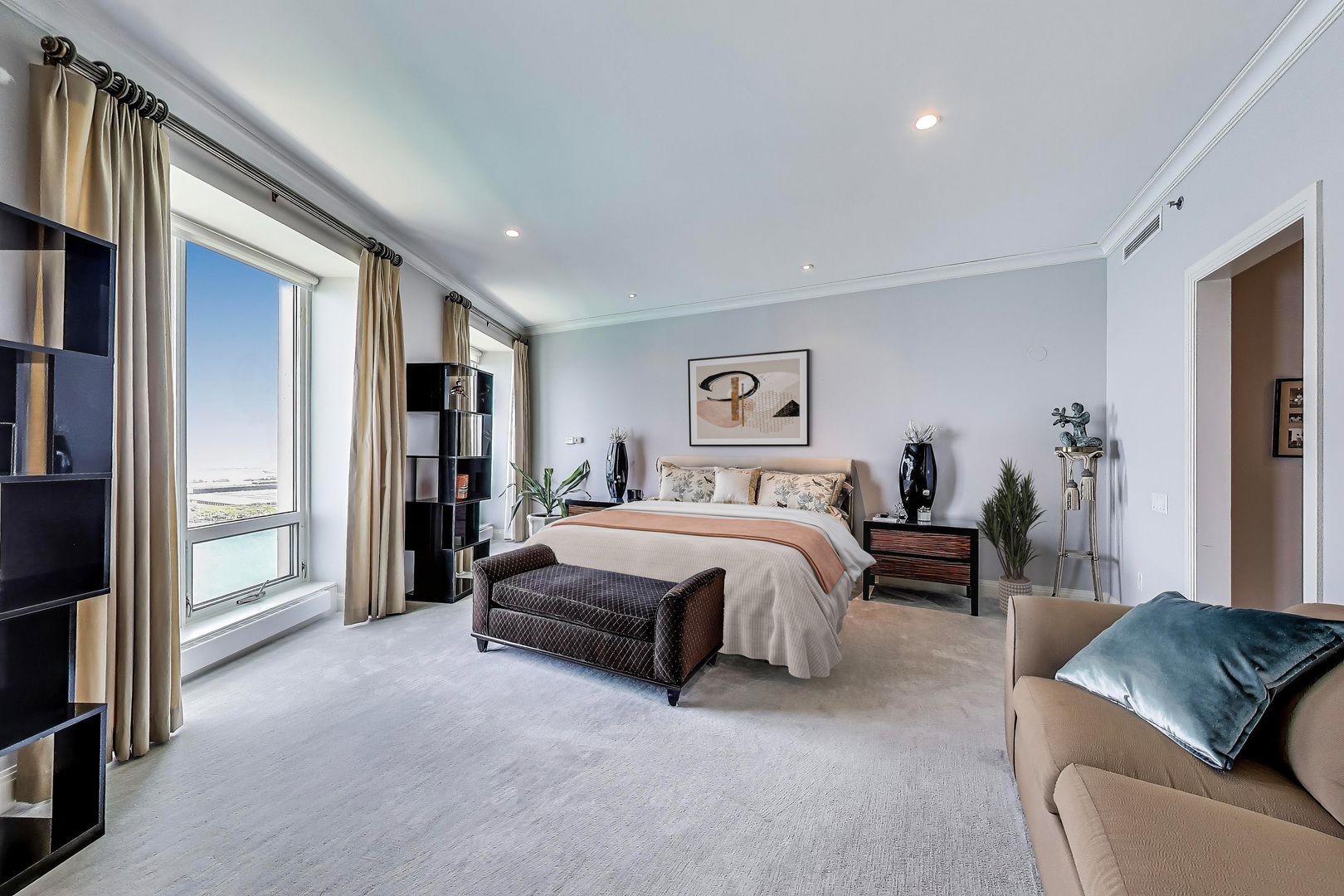 840 North Lake Shore Drive, Unit 2401 Chicago, IL 60611 - Photo 27 of 40 a spacious bedroom with a bed a couch and a walk in closet