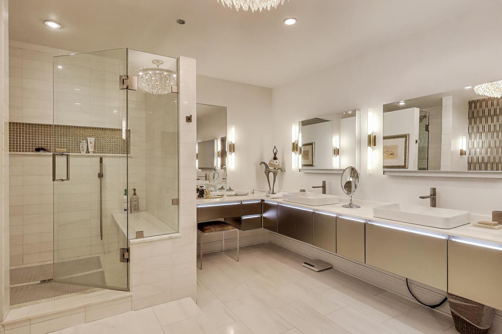 840 North Lake Shore Drive, Unit 2401 Chicago, IL 60611 - Photo 31 of 40 a large white kitchen with a sink and stainless steel appliances