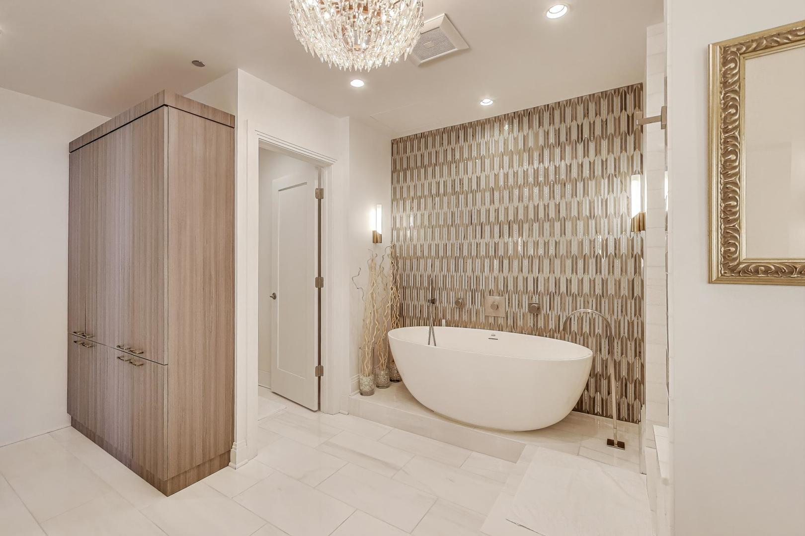 840 North Lake Shore Drive, Unit 2401 Chicago, IL 60611 - Photo 32 of 40 a bathroom with a tub and shower