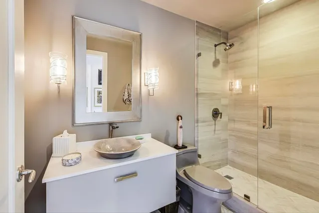 a bathroom with a sink toilet and shower