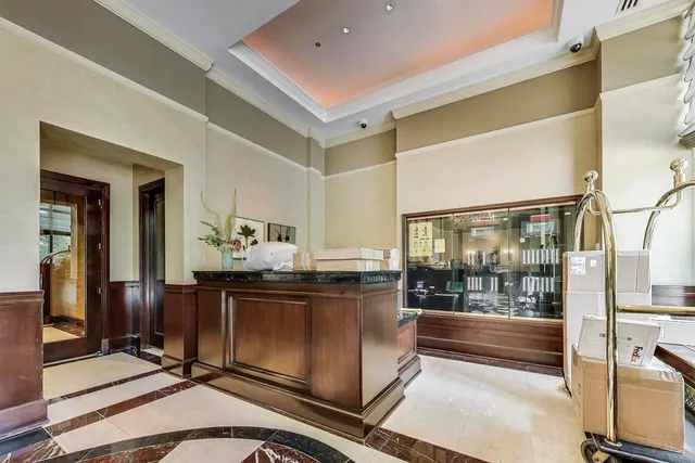 a view of a very nice looking dining room with a large mirror and chandelier