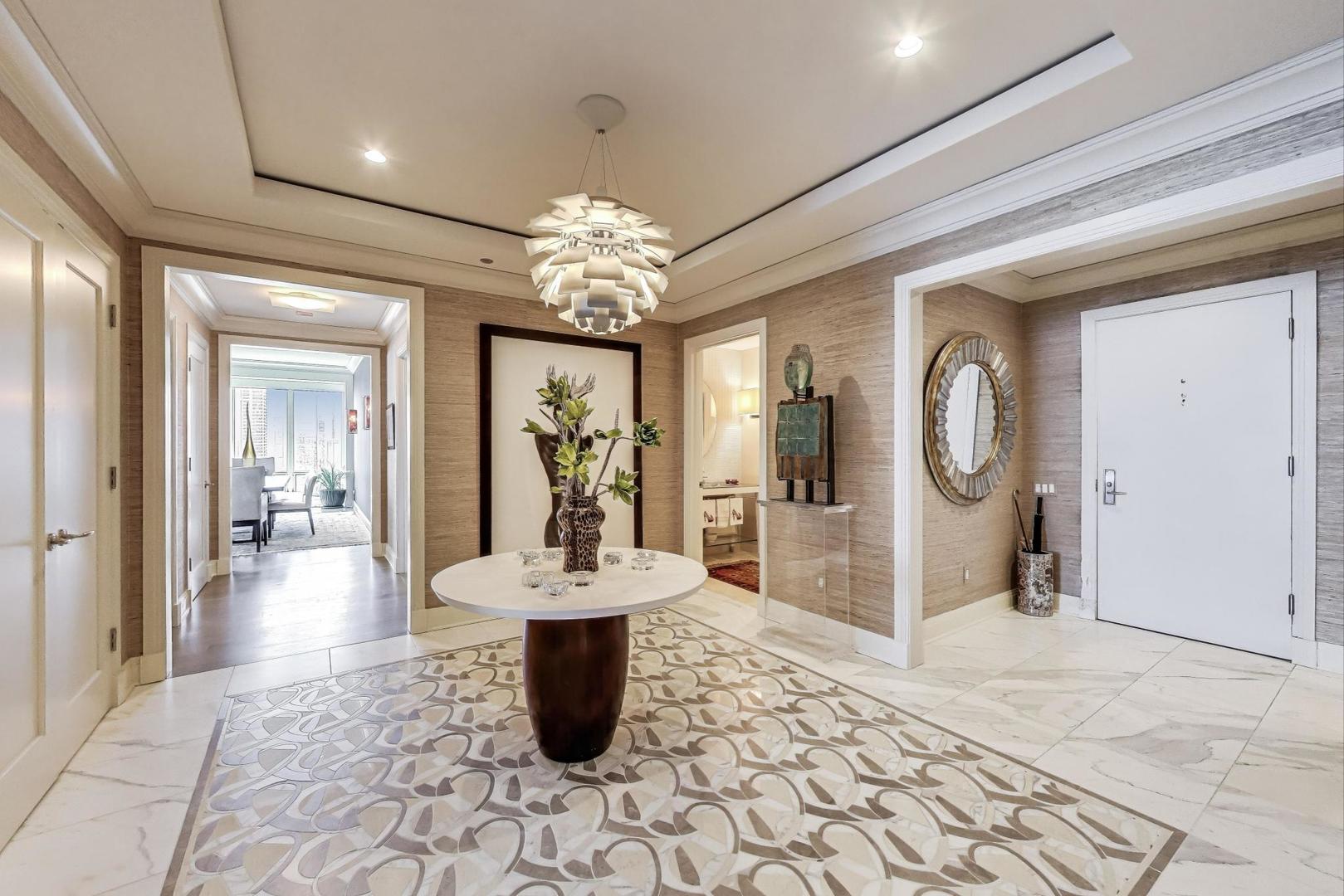 840 North Lake Shore Drive, Unit 2401 Chicago, IL 60611 - Photo 7 of 40 a view of a very nice looking dining room with a large mirror and chandelier