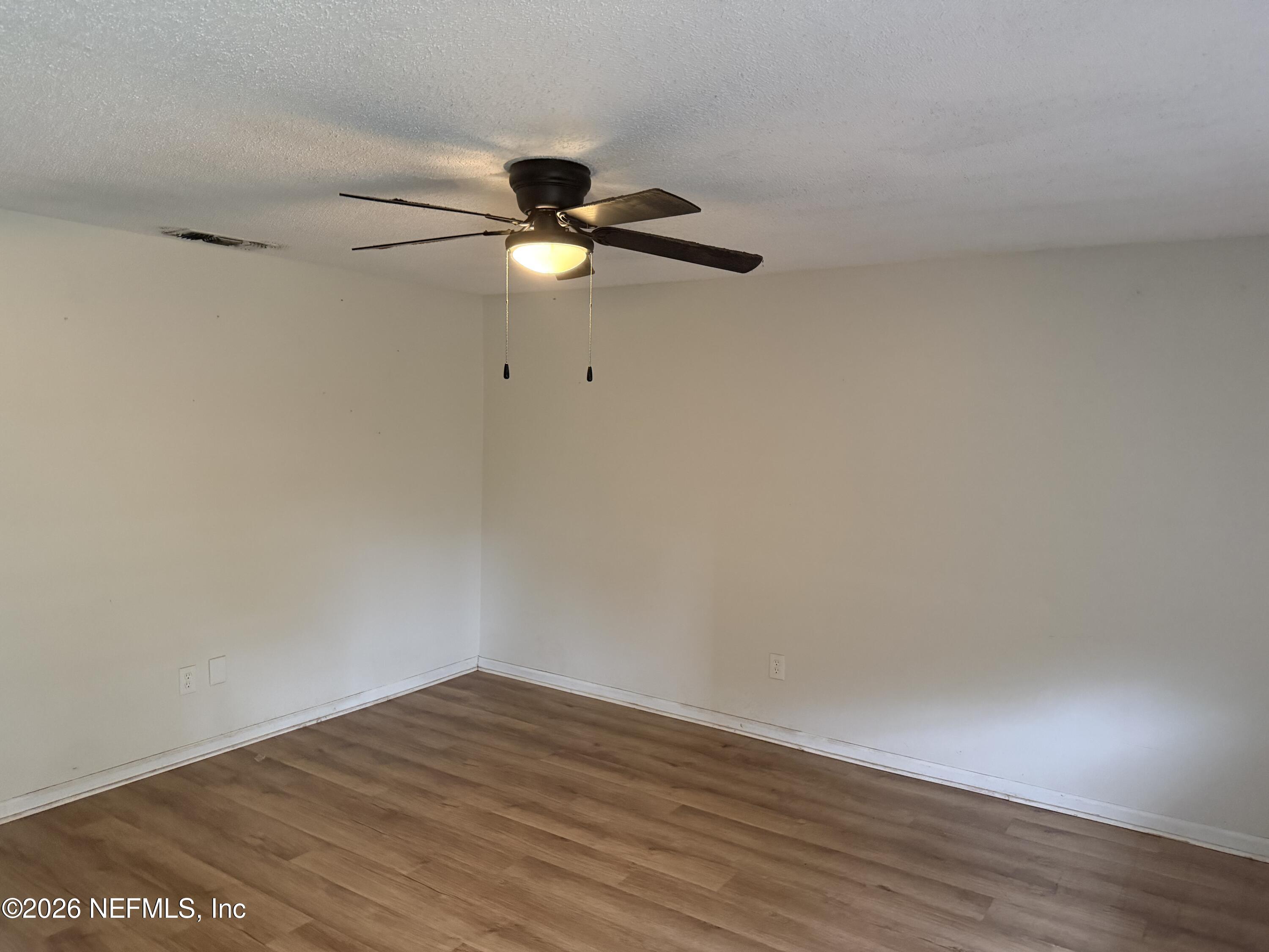 7539 Walden Road Jacksonville, FL 32244 - Photo 4 of 18 a view of an empty room with wooden floor