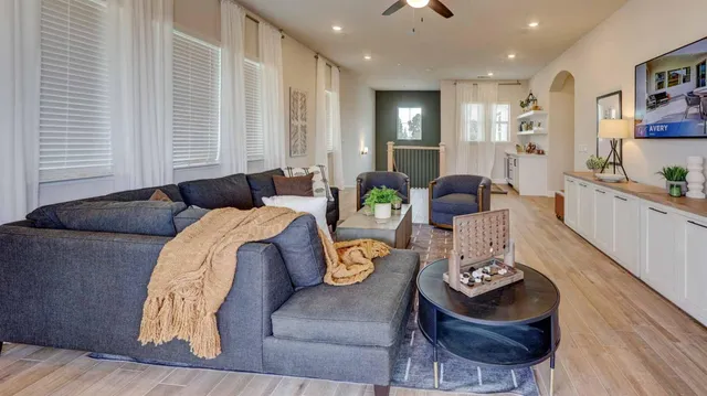 a living room with furniture and wooden floor