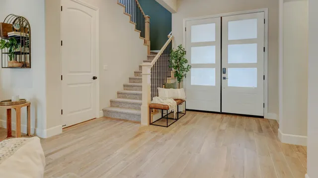 a view of an empty room with stairs and ventilation