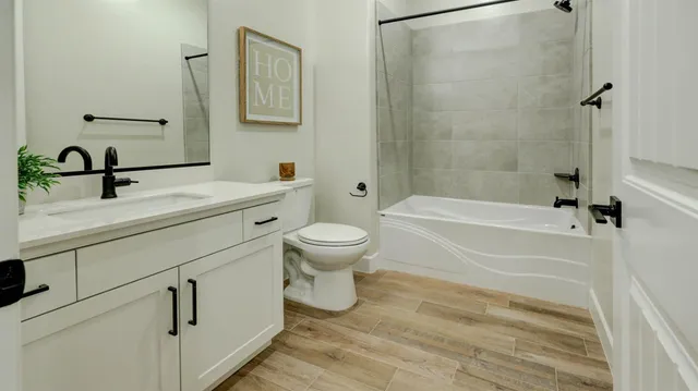 a bathroom with a sink a toilet and a bathtub