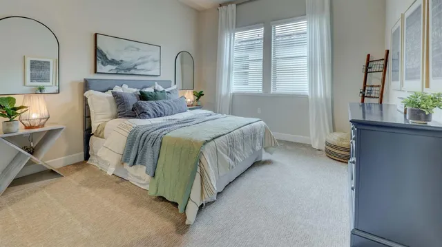 a bedroom with a bed and a painting on the wall