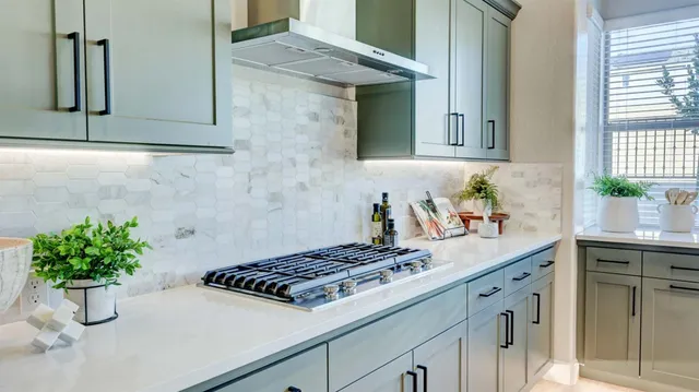 a kitchen with a white stove and cabinets
