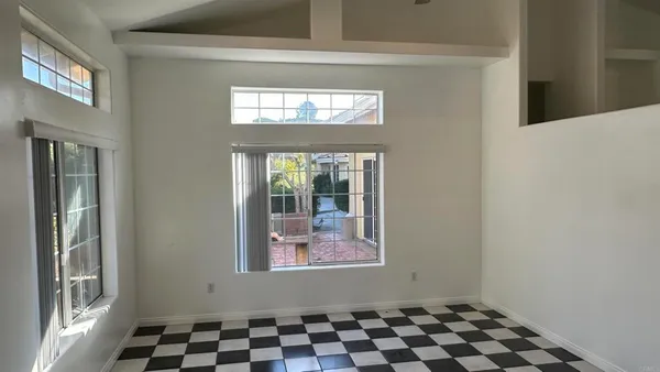 a view of a livingroom with wooden floor and a window
