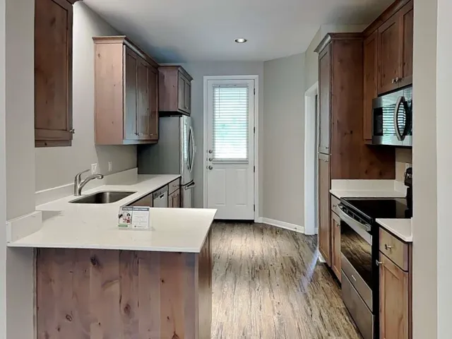 a kitchen with a stove and a refrigerator