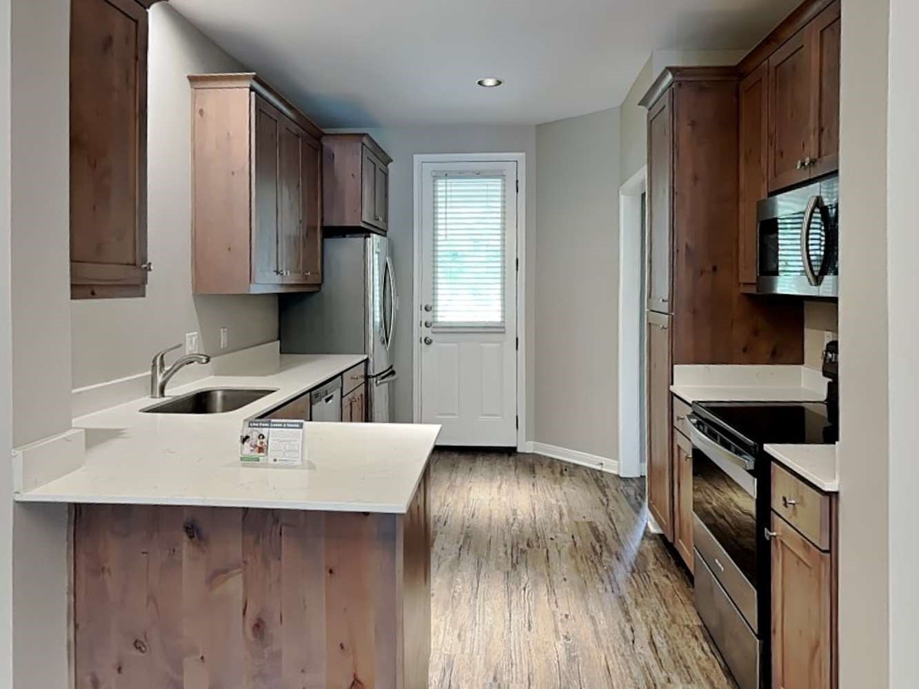 179 Holly Street, Unit 503 Georgetown, TX 78626 - Photo 5 of 18 a kitchen with a stove and a refrigerator