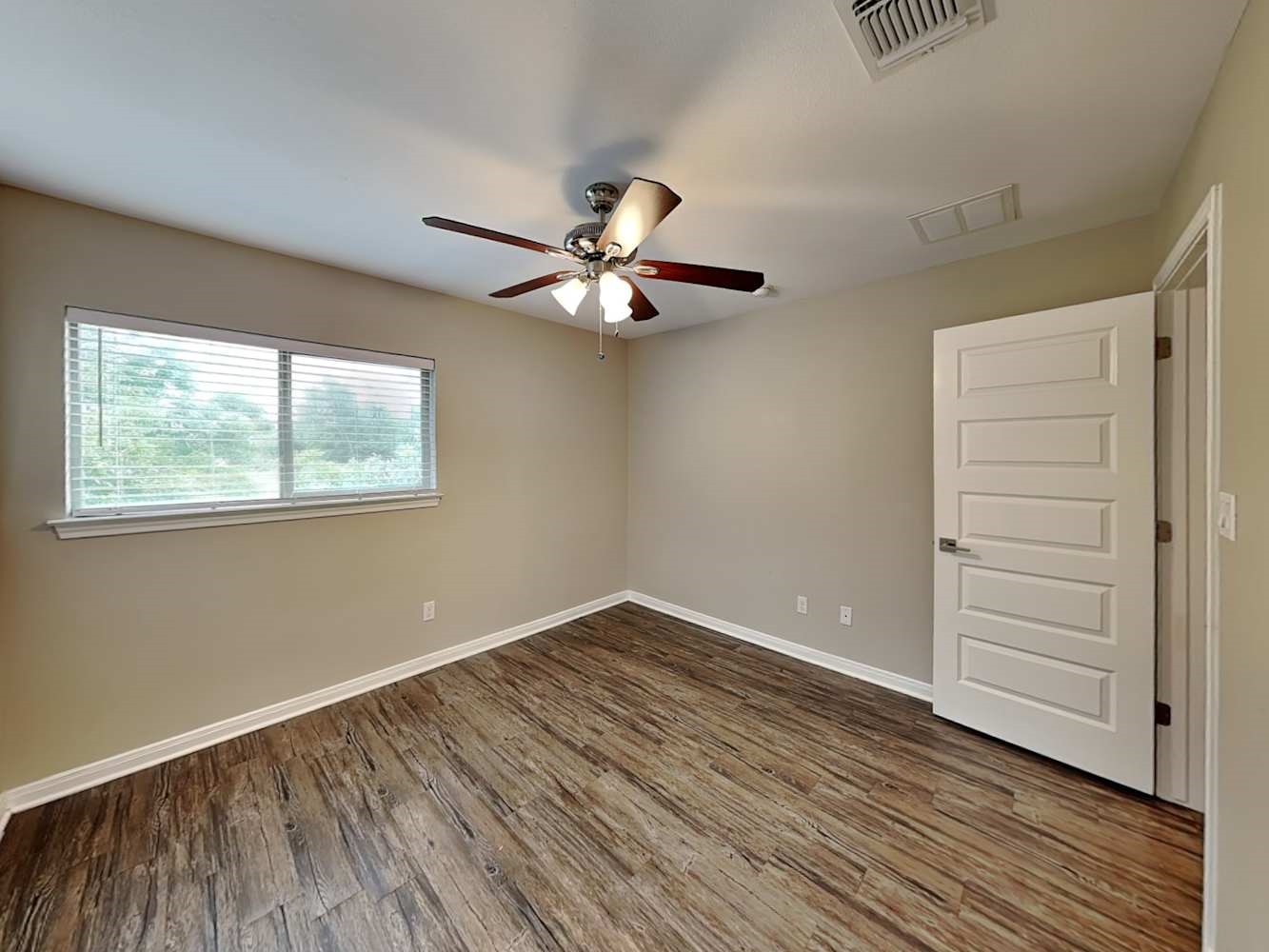 179 Holly Street, Unit 503 Georgetown, TX 78626 - Photo 10 of 18 an empty room with wooden floor chandelier fan and windows