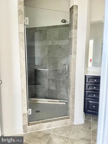 a bathroom with a shower a sink and a mirror