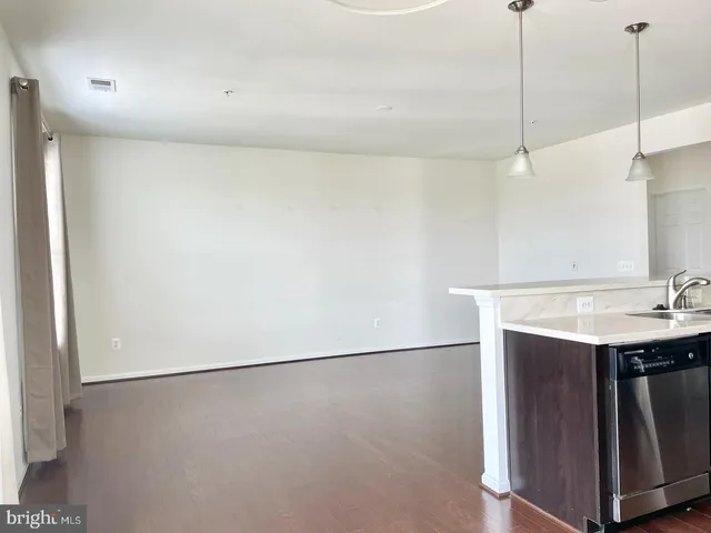 a view of a kitchen with a sink and a refrigerator