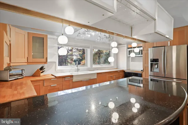 a view of a kitchen with a sink and a large window