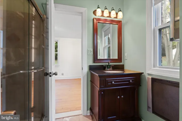 a bathroom with a sink a mirror and a window
