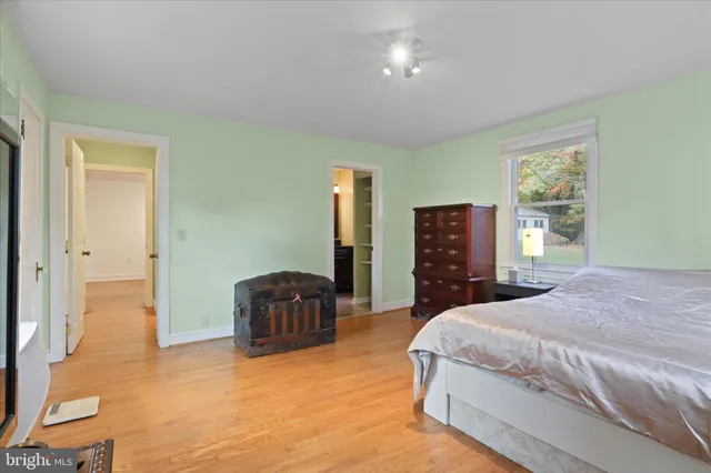 a spacious bedroom with a bed and furniture