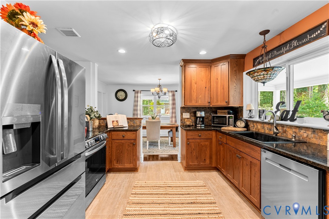 1159 Cedar Hill Road Blackstone, VA 23824 - Photo 12 of 45 a kitchen with stainless steel appliances granite countertop sink stove and refrigerator