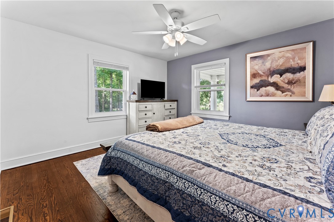 1159 Cedar Hill Road Blackstone, VA 23824 - Photo 13 of 45 a bedroom with a large bed a chandelier and a window