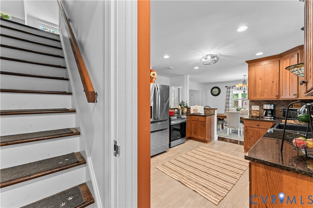 1159 Cedar Hill Road Blackstone, VA 23824 - Photo 23 of 45 a kitchen with stainless steel appliances kitchen island granite countertop a stove a sink and a refrigerator