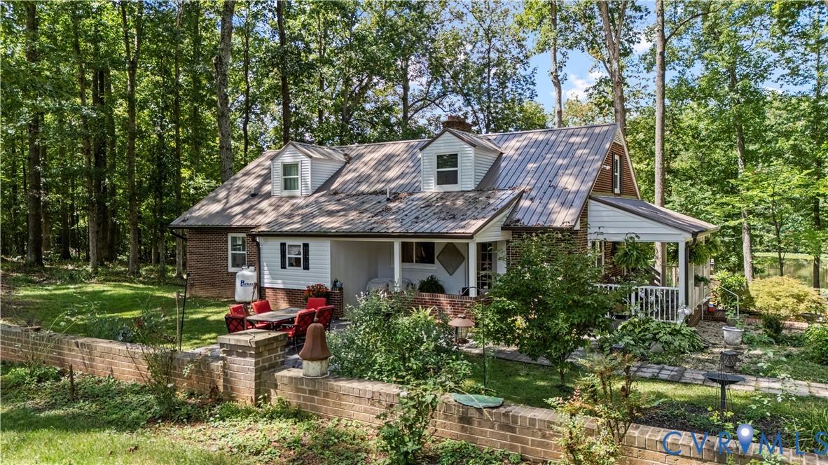1159 Cedar Hill Road Blackstone, VA 23824 - Photo 3 of 45 a front view of house with a garden and patio