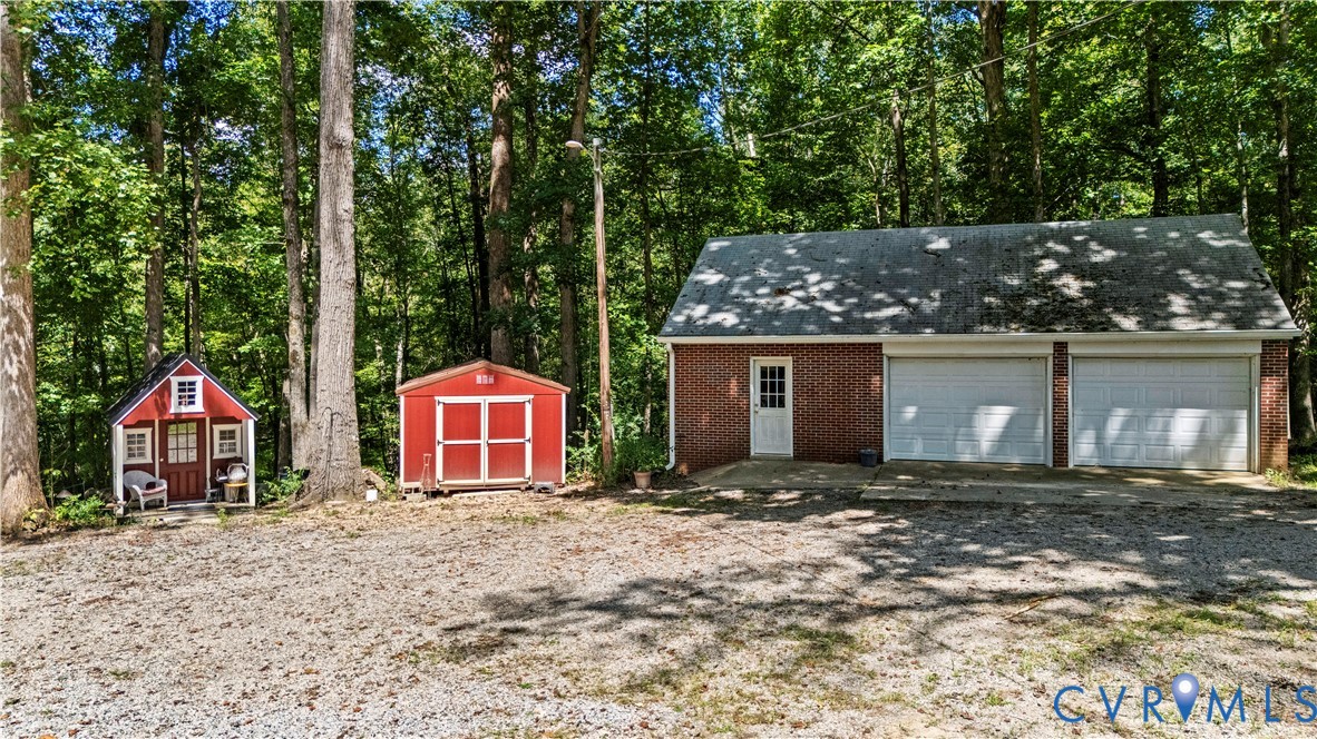 1159 Cedar Hill Road Blackstone, VA 23824 - Photo 38 of 45 a front view of a house with a yard and garage
