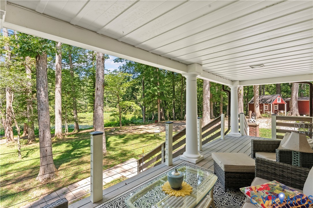 1159 Cedar Hill Road Blackstone, VA 23824 - Photo 39 of 45 a living room with furniture and floor to ceiling windows