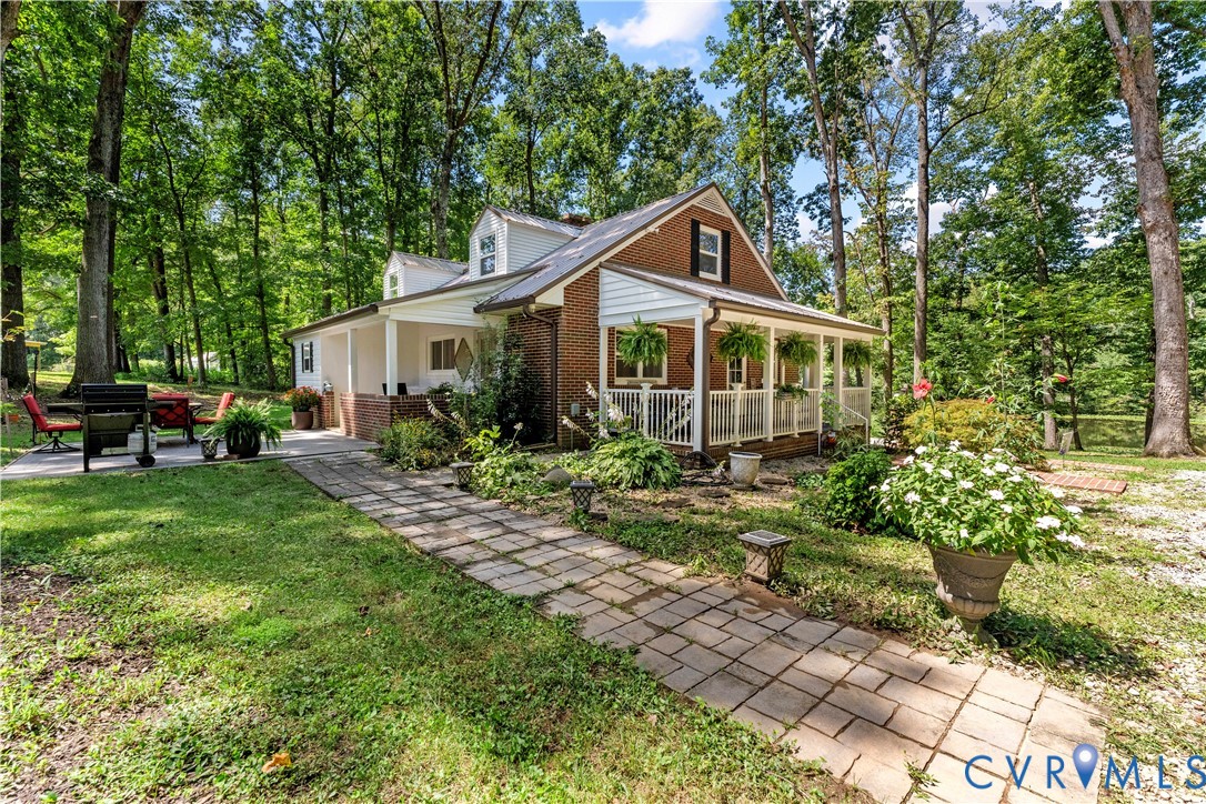1159 Cedar Hill Road Blackstone, VA 23824 - Photo 4 of 45 a front view of a house with a garden