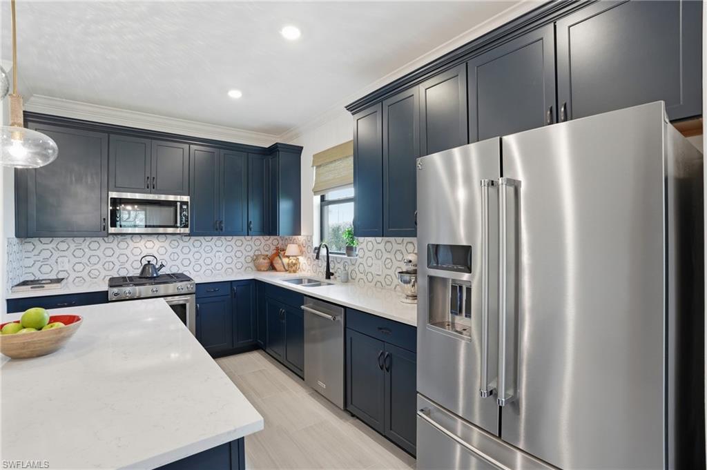 1955 Sierra Court Naples, FL 34120 - Photo 12 of 50 a kitchen with stainless steel appliances a refrigerator sink and microwave