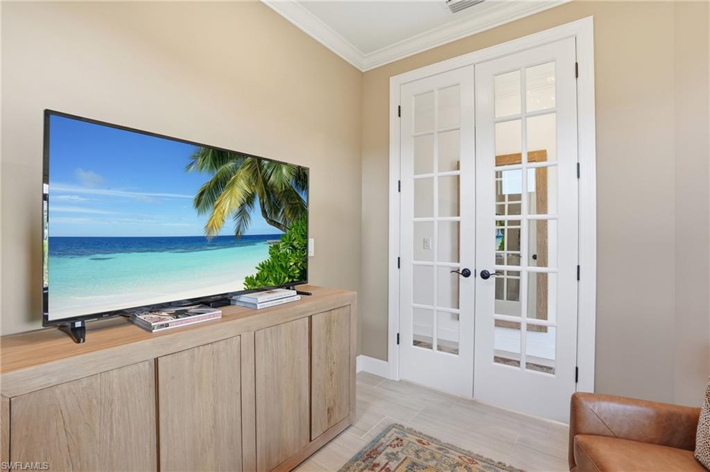 1955 Sierra Court Naples, FL 34120 - Photo 15 of 50 a living room with a flat screen tv and a walk in closet